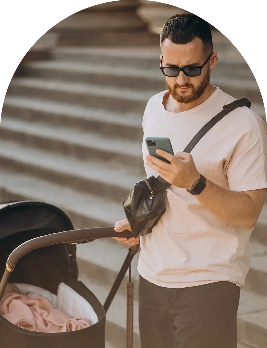 Man using phone and walking baby